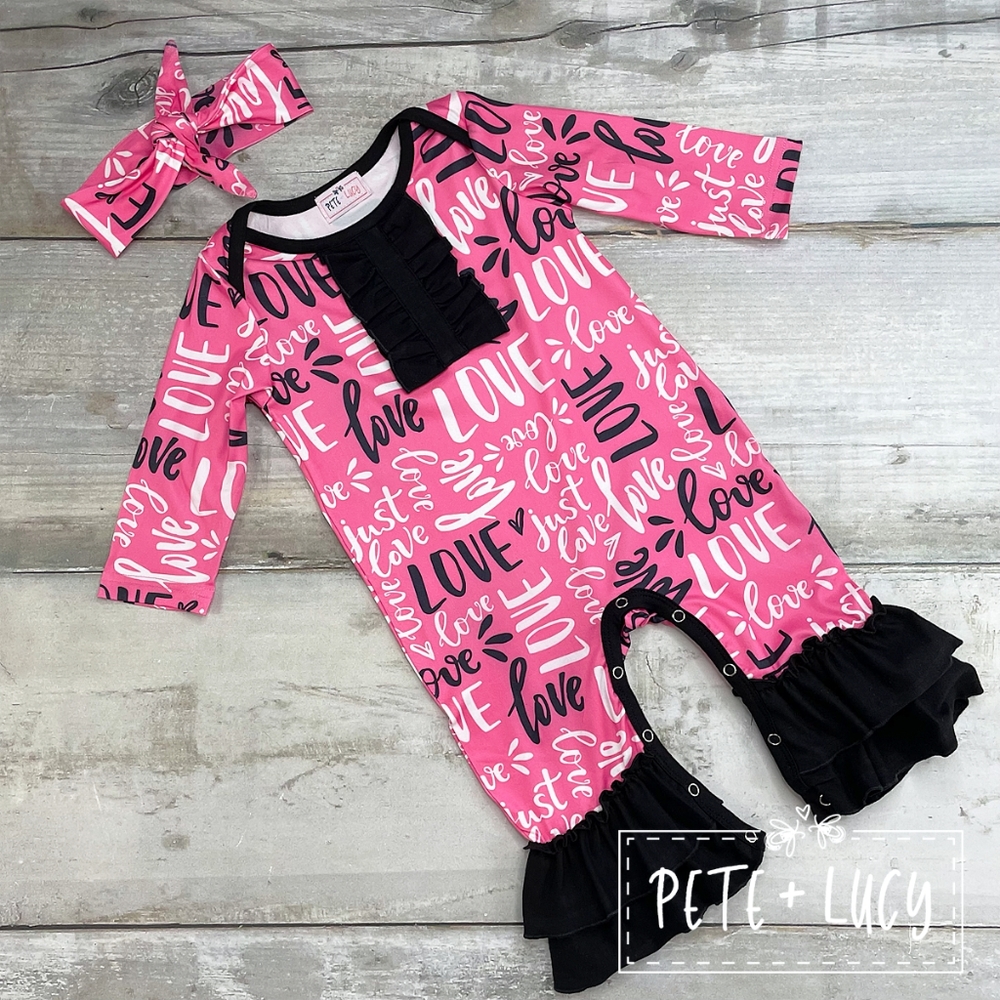 Baby girl romper from the just love collection black pink ruffles Pete and Lucy